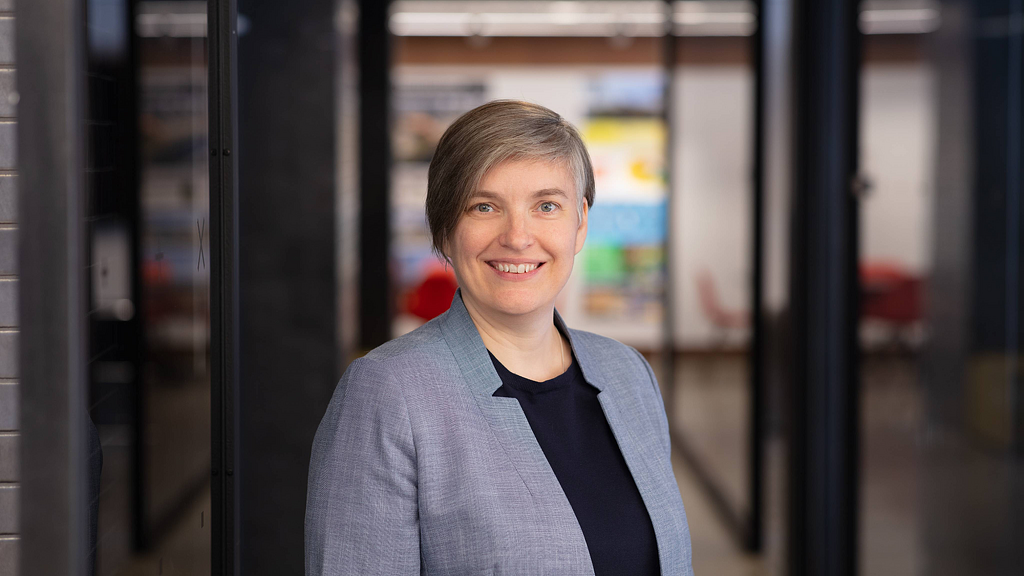 A person smiling in a room.